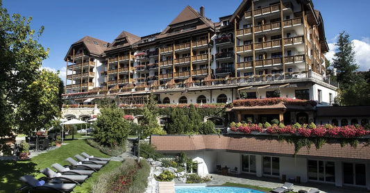 External view of Park Gstaad Hotel with pool and lounge area