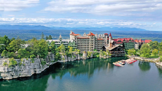 exterior shot of the hotel Mohonk Mountain House which is built on a mountain with a central view of the lake