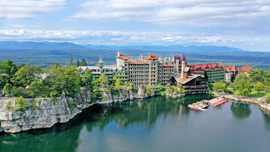 exterior shot of the hotel Mohonk Mountain House which is built on a mountain with a central view of the lake 