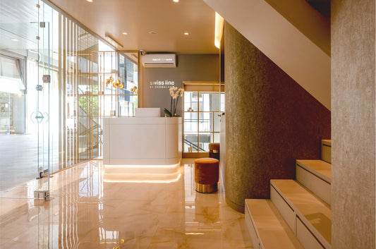 Swissline boutique reception with rose coloured marble and gold tones