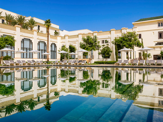 External pool view of Fairmont Tazi Palace designed to emphasize the native Moroccan character surrounding with trees