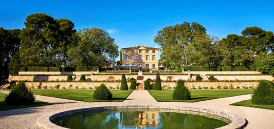 external view of CHÂTEAU DE LA GAUDE, AIX-EN-PROVENCE with a small font, trees and paths